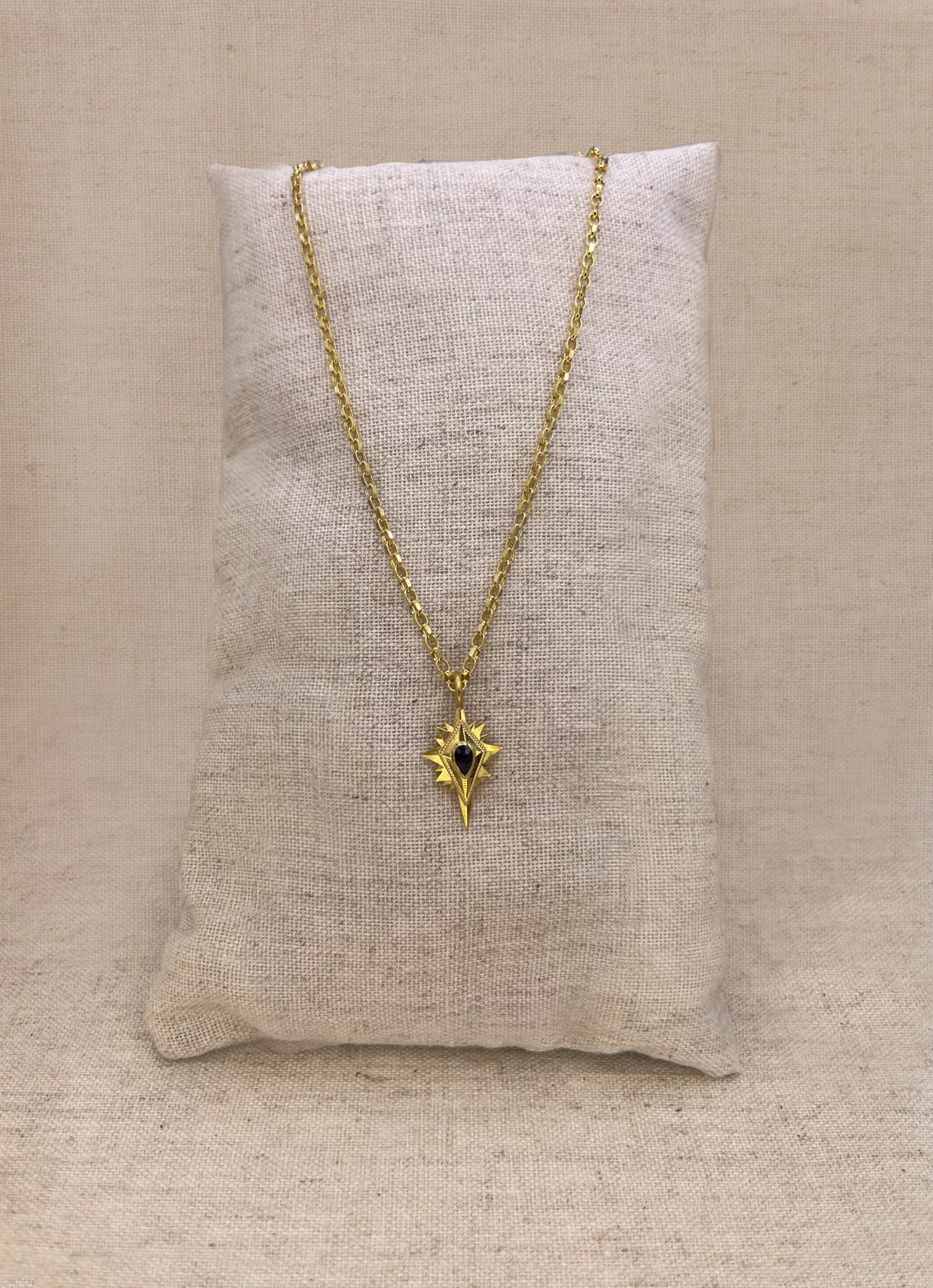 Gold northern star pendant with black spinel, on belcher chain