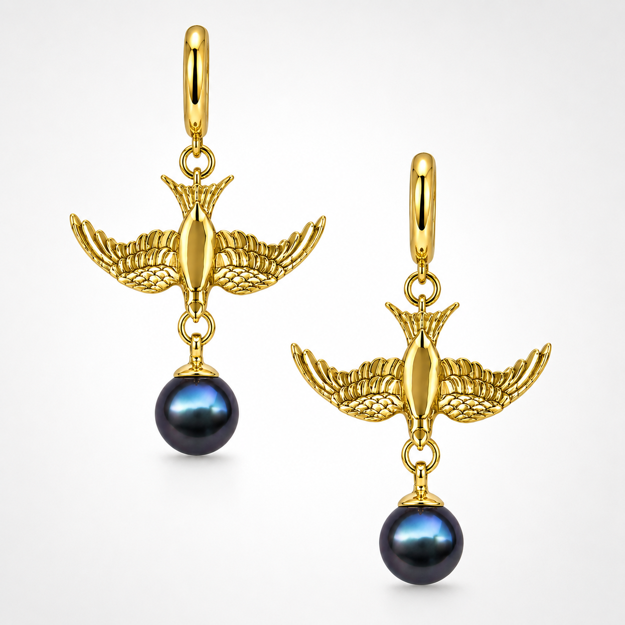 Gold swallow earring with pear charm