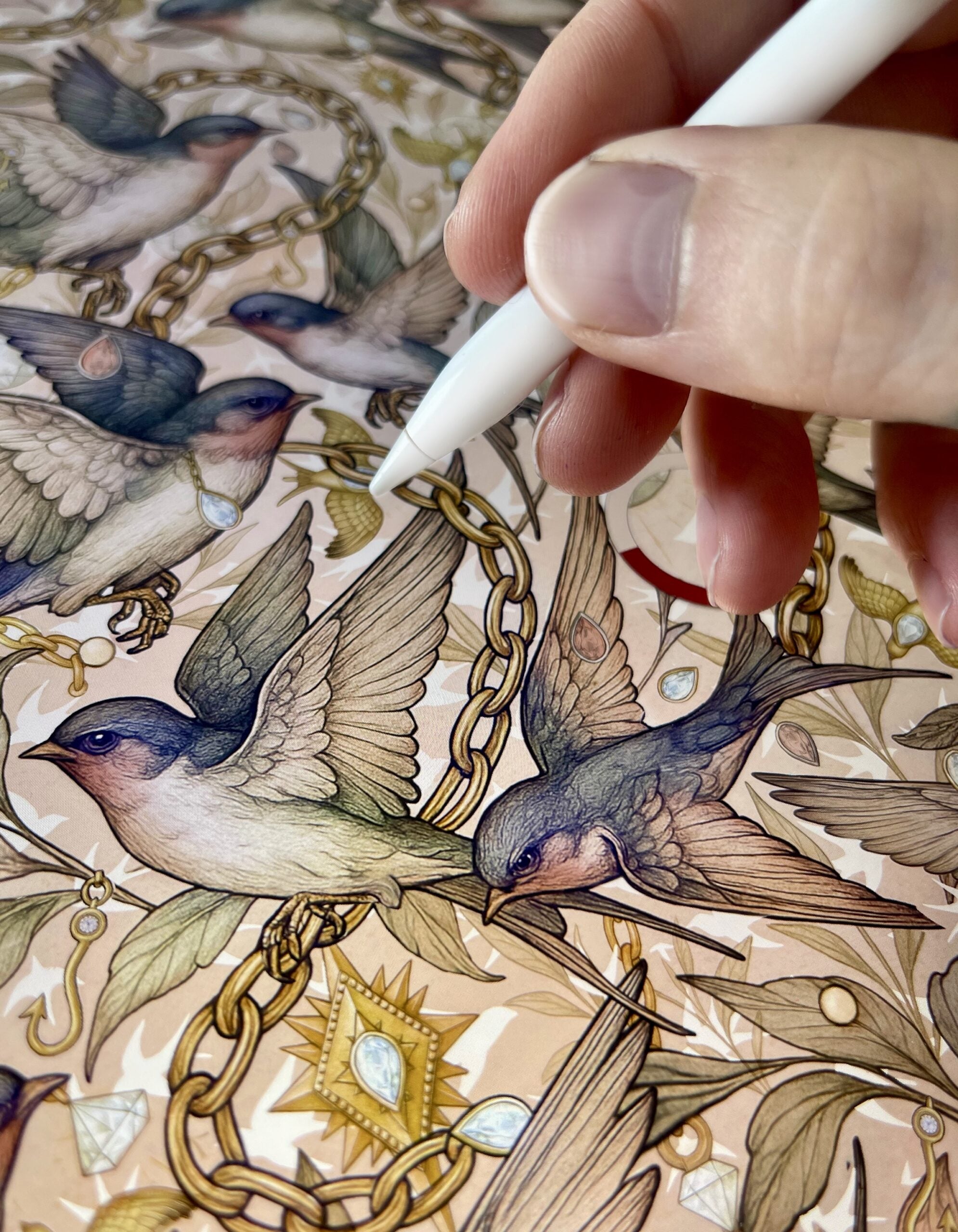 Digital illustration in progress of swallows, chains, and celestial motifs being drawn with an Apple Pencil.