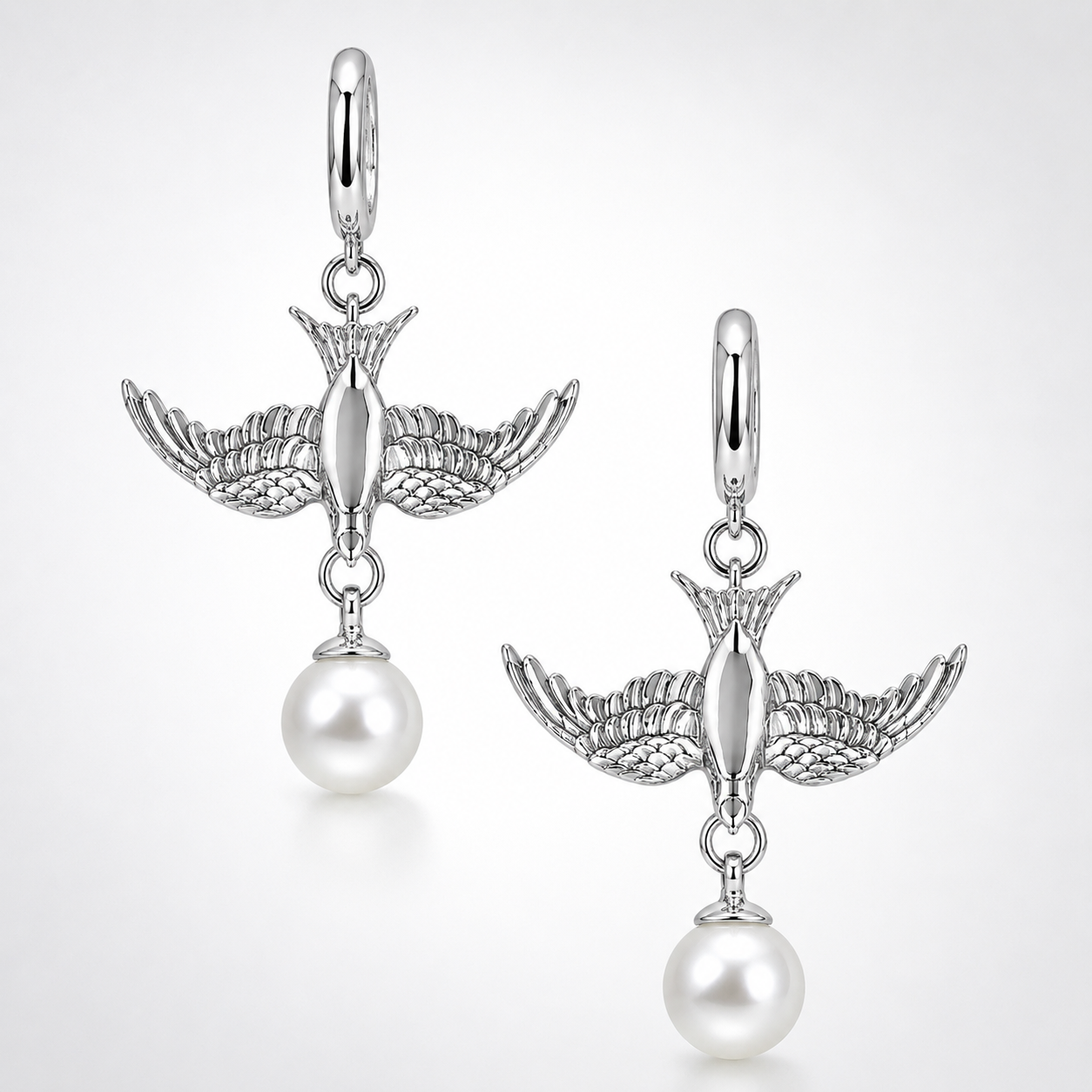 Gold swallow earring with pear charm