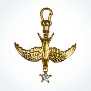 A polished yellow gold swallow charm on an Albert swivel clasp, featuring a star-cut white gemstone drop.