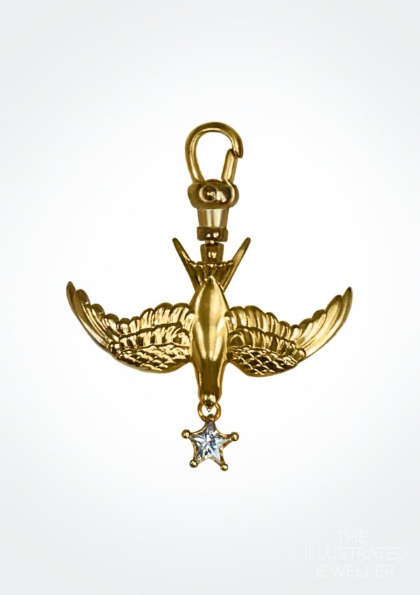 A polished yellow gold swallow charm on an Albert swivel clasp, featuring a star-cut white gemstone drop.