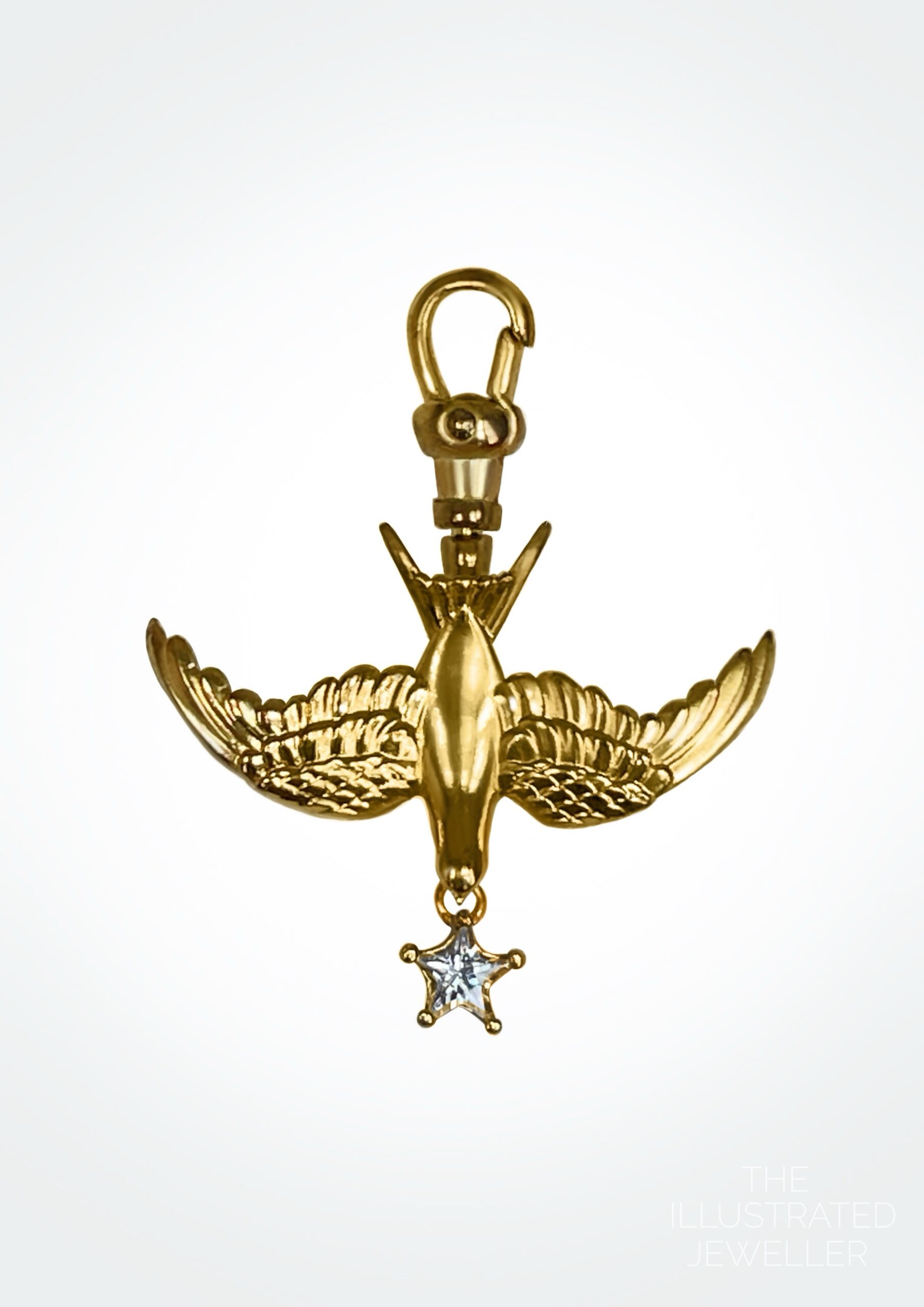 A polished yellow gold swallow charm on an Albert swivel clasp, featuring a star-cut white gemstone drop.